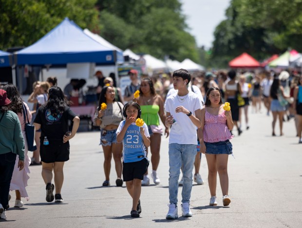 People eat and shop the vendor stalls on June 22,...