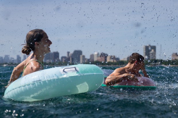 Madison Peppa, left, and Eryk Fundakowski get splashed by their...