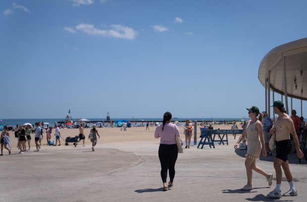 People walk around North Avenue Beach on June 22, 2025....
