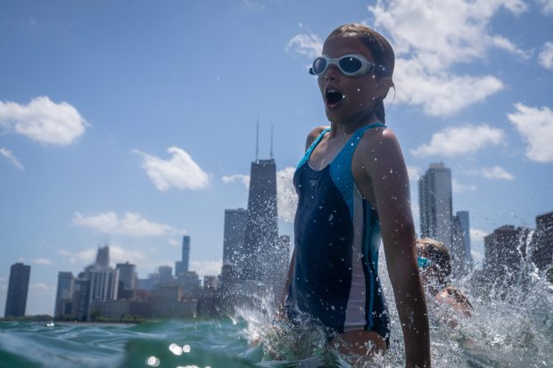 Emerson DeCamp, 10, leaps in the water at the pier...