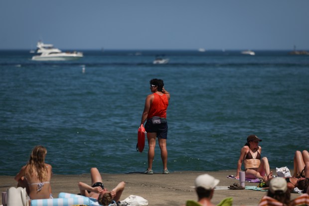 A lifeguard monitors the water near Oak Street Beach on...