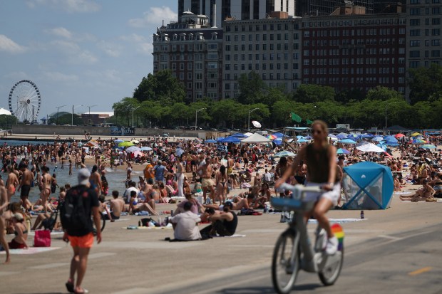 Hundreds of people enjoy the summer heat at Oak Street...