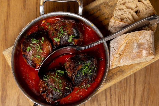 Chorizo-stuffed and bacon wrapped dates served with bread at Avec in Chicago's West Loop. (Dominic Di Palermo/Chicago Tribune)