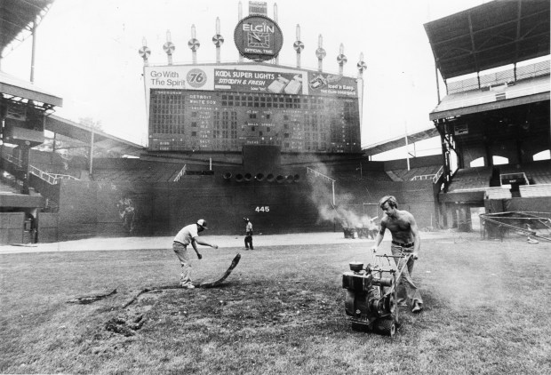 On July 13, 1979, workmen replace sod at Comiskey Park that was damaged by the previous day's Disco Demolition promotoion. They also had to clear the field of debris broken disco records and repair the infield. (Carl Hugare/Chicago Tribune)