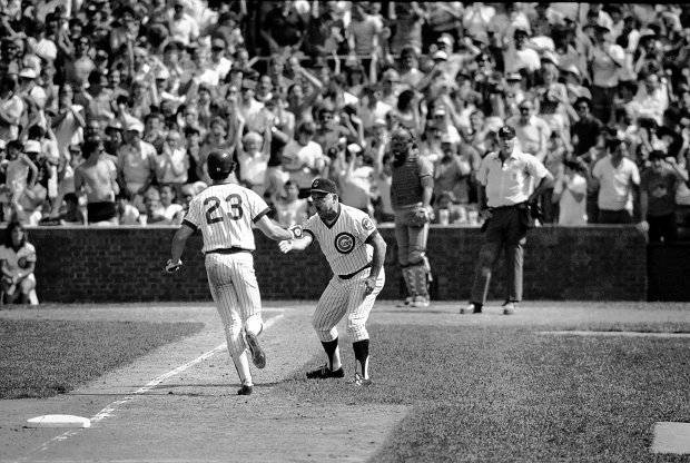Ryne Sandberg is congratulated by Chicago Cubs third base coach Don Zimmer after evening the score in the ninth inning with a home run against the Cardinals on June 23, 1984. (Charles Cherney/Chicago Tribune)