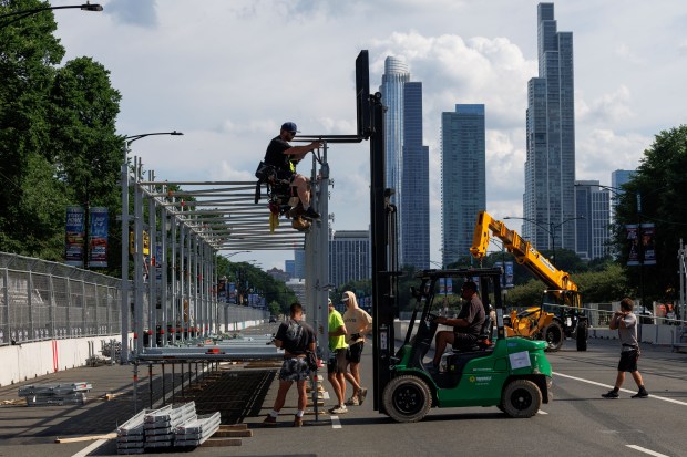 Workers put up barricades and scaffolding on South Columbus Drive, June 30, 2025, in preparation for the upcoming NASCAR Chicago Street Race scheduled for the 4th of July weekend in Chicago. (Armando L. Sanchez/Chicago Tribune)