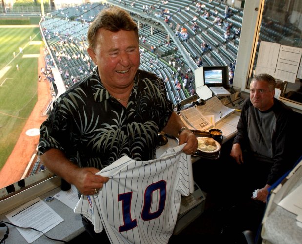 Chicago Cubs great Ron Santo in the Wrigley Field booth where he provides commentary for WGN radio holds a jersey with his No. 10, on Sept. 15, 2003, in Chicago. (Nuccio DiNuzzo/Chicago Tribune)