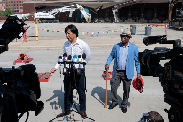 Soo Kim, the Chairman of Bally's Corporation, talks with the news media beside Ald. Walter Burnett as Bally's Chicago Casino hosts a demolition event at the former Chicago Tribune Freedom Center on Aug. 27, 2024, to mark a major construction milestone. (Antonio Perez/Chicago Tribune)