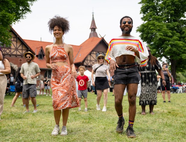 Danielle Russell, left, and Forrest Parks join a salsa dancing class Sunday, July 13, 2025, during the 25th annual Barrio Arts Festival at the National Puerto Rican Museum in Humboldt Park. (Brian Cassella/Chicago Tribune)