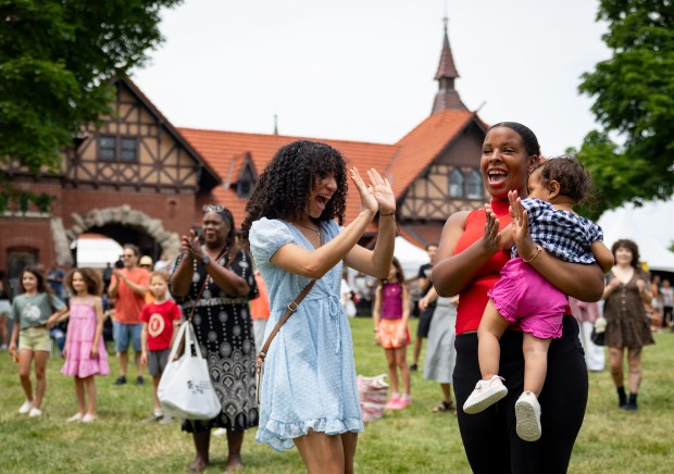 Arriette G., left, and Naomi K. with Anahi, 1, join a salsa dancing class Sunday, July 13, 2025, during the 25th annual Barrio Arts Festival at the National Puerto Rican Museum in Humboldt Park. (Brian Cassella/Chicago Tribune)