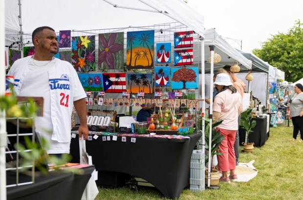 Attendees browse the vendor booths Sunday, July 13, 2025, during the 25th annual Barrio Arts Festival at the National Puerto Rican Museum in Humboldt Park. (Brian Cassella/Chicago Tribune)