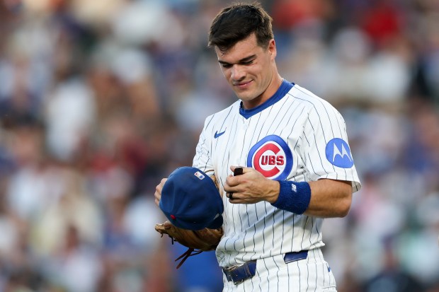 Cubs third baseman Matt Shaw puts on his cap before the third inning against the Guardians on Tuesday, July 1, 2025, at Wrigley Field. (Armando L. Sanchez/Chicago Tribune)