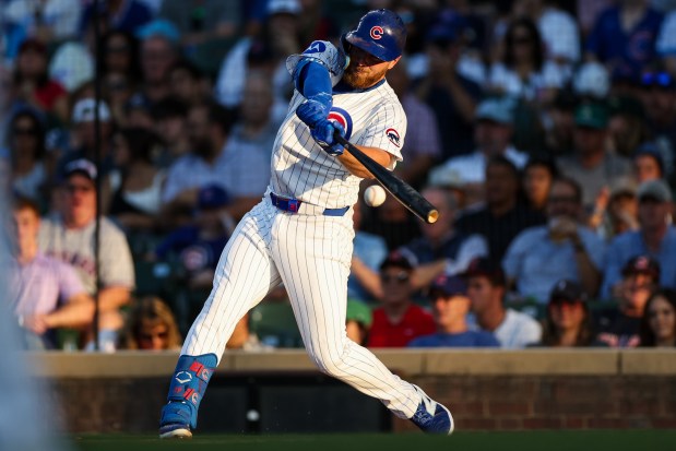 Cubs first baseman Michael Busch hits an RBI single during the second inning against the Guardians on Tuesday, July 1, 2025, at Wrigley Field. (Armando L. Sanchez/Chicago Tribune)