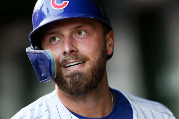 Cubs first baseman Michael Busch walks through the dugout after scoring on a two-run double by catcher Carson Kelly during the second inning against the Guardians on Tuesday, July 1, 2025, at Wrigley Field. (Armando L. Sanchez/Chicago Tribune)