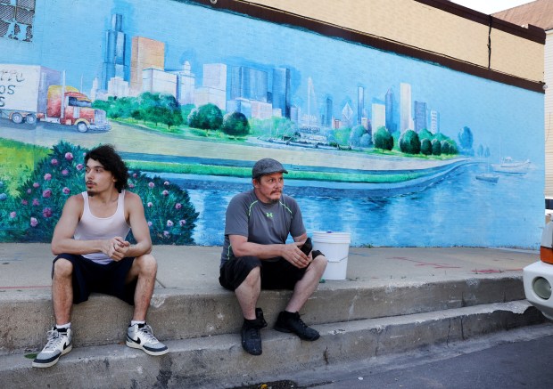 John Drexel, right, and his son, Aidan Drexel, 18, wait...