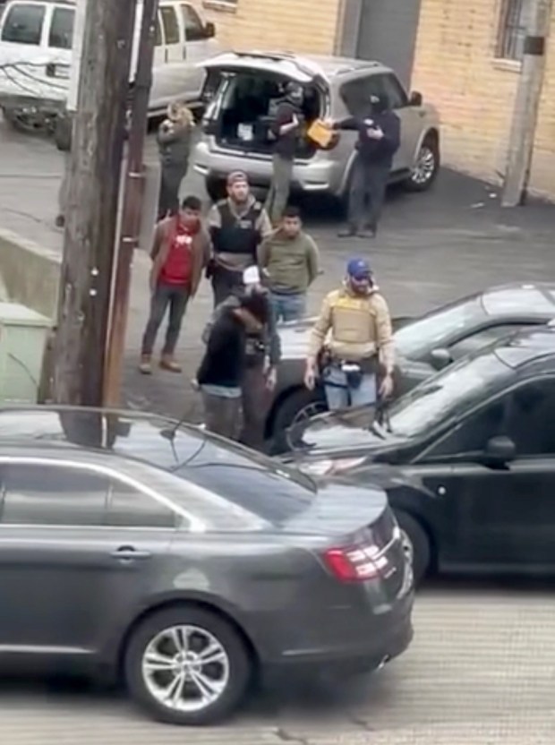 Agents wearing black detain several people at the intersection of Chicago Street and Route 31 in Elgin in late April, 2025. The individuals were arrested when agents stopped a van containing workers at this location. (Ismael Cordova-Clough)