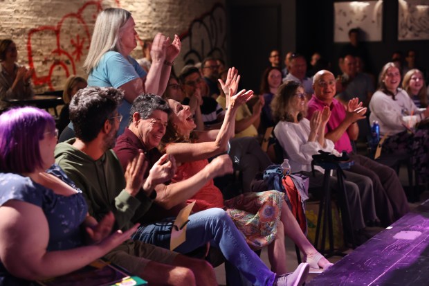 Audience members react during a team improv performance by The...