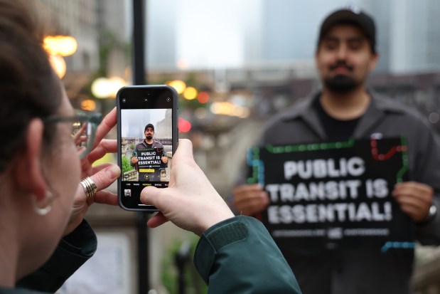 Dozens of transit workers and supporters gather to urge riders to call state representatives to avoid a "transit death spiral" during a rally in downtown Chicago on May 21, 2025. (Antonio Perez/Chicago Tribune)