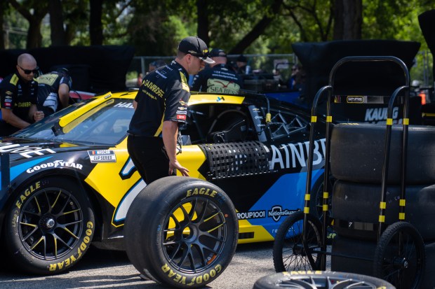 Brandt's race car gets its wheels put on by the...