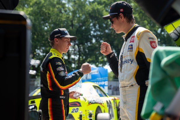 Menard's/Dutch Boy’s Ryan Blaney (12), left, fist bumps Starkey’s William...