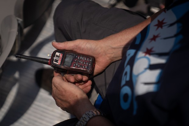 Scott Landeck listens to the communication between drivers during the...