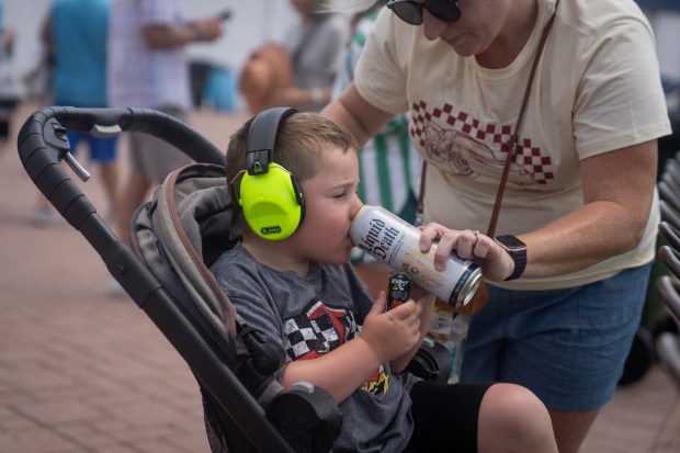Katie O’Gorman helps her son, Finn O’Gorman, 5, drink Liquid...