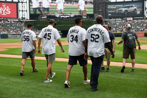 Former Chicago White Sox pitchers José Contreras, from left, Freddy García, Jon Garland, and Mark Buehrle walk to the mound to throw out the first pitch together before the game against the Cleveland Guardians at Rate Field on Sunday, July 13, 2025. (Eileen T. Meslar/Chicago Tribune)