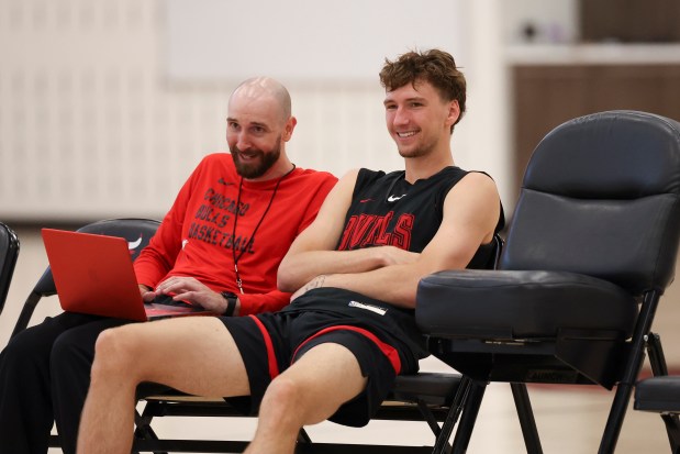 Bulls forward Matas Buzelis, right, speaks with player development coordinator Peter Crawford practice on July 7, 2025, at the Advocate Center. (Eileen T. Meslar/Chicago Tribune)
