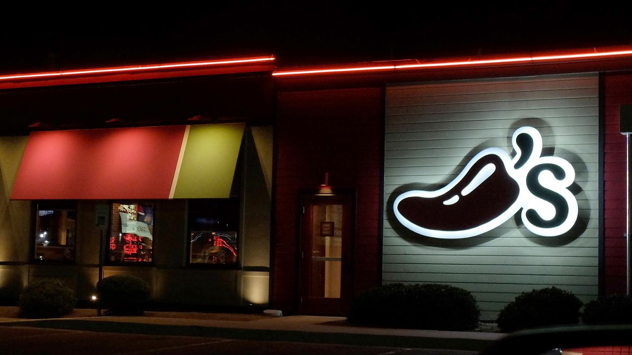 A Chili's restaurant logo stands lit in El Paso, Tex., Wednesday, Oct. 23, 2019. (AP Photo/Rogelio V. Solis)