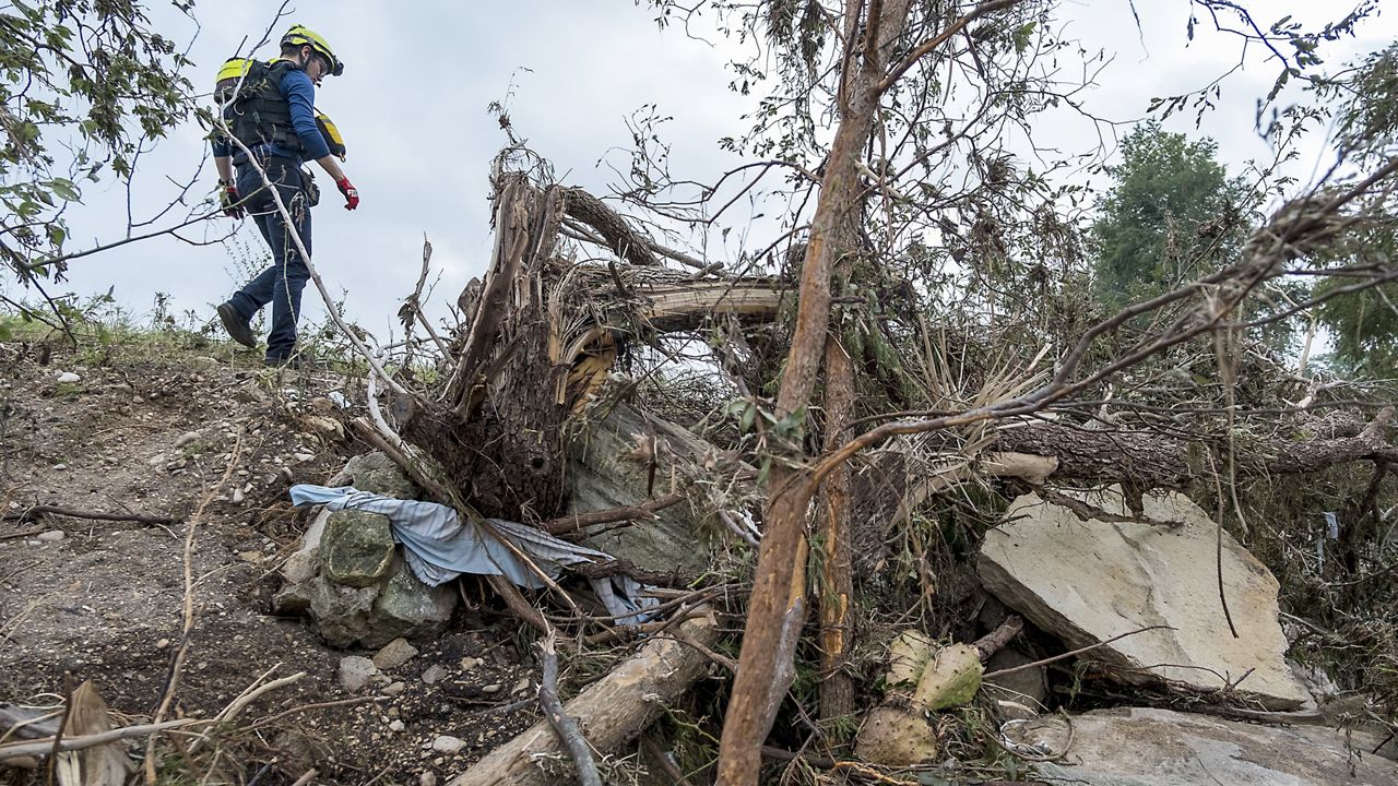 First responders from College Station Fire Department search along the banks of the Guadalupe River, as rescue efforts continue following extreme flooding, Sunday, July 6, 2025, in Ingram, Texas. (AP Photo/Rodolfo Gonzalez)