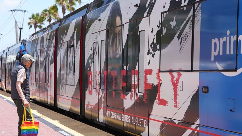 Trolleys are wrapped with TV promotions during Comic- Con. (Photo by Chris Stone/Times of San Diego)