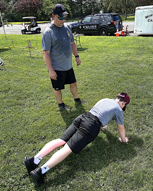 Paul Graham, 14, of Radnor does push-ups after losing what he called a "friendly" archery competition. (PETE BANNAN-DAILY TIMES)