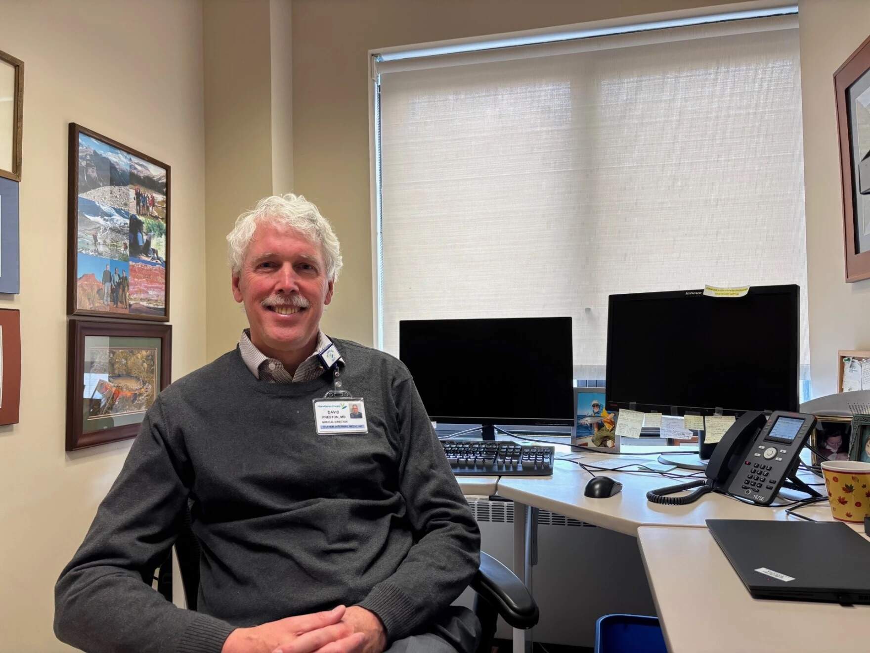Dr. David Preston sits at his desk in Waterville, Maine. (Patty Wight/Maine Public)