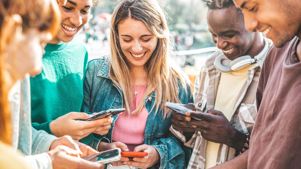 Young people with mobile phones.