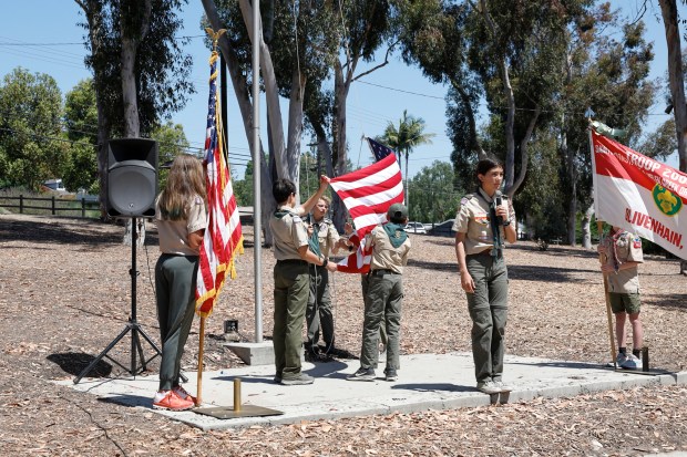 Color guard from Scout Troop 2000 raise the flag at...