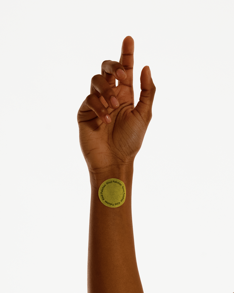 Person's arm with a Kind Patches sticker.