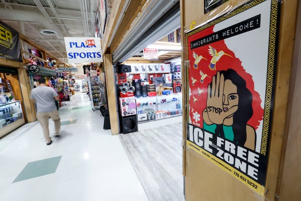A sign inside Plaza Fiesta on Wednesday, May 7, 2025, welcomes all immigrants. However, some shop owners are noticing a drop in their sales, which they believe is due to policies from the Trump administration that have caused worry among immigrant communities. (Miguel Martinez/AJC)