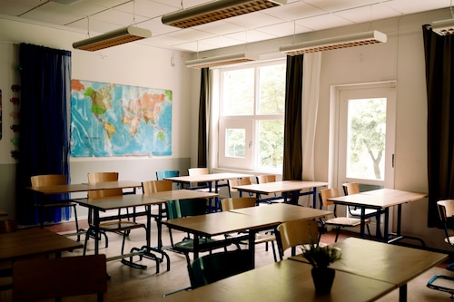 Empty desks and chairs in a school classroom
