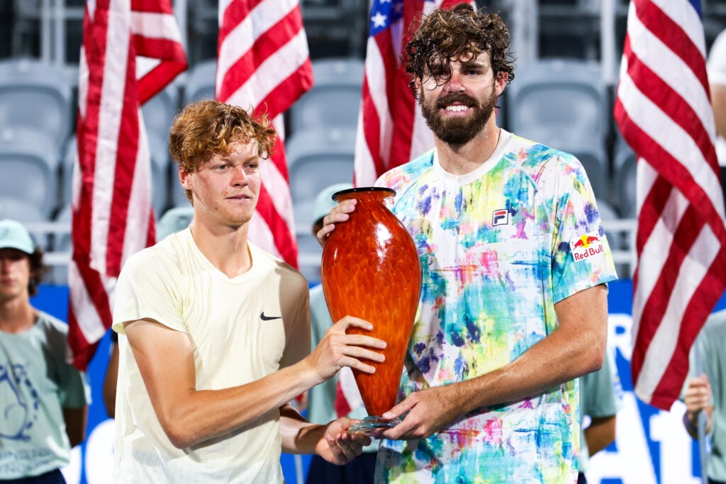 Jannik Sinner of Italy and Reilly Opelka of the United States pose for photos with the winners trophy after the pair won the doubles final match against Steve Johnson of the United States and Jordan Thompson of Australia at the Truist Atlanta Open at Atlantic Station.