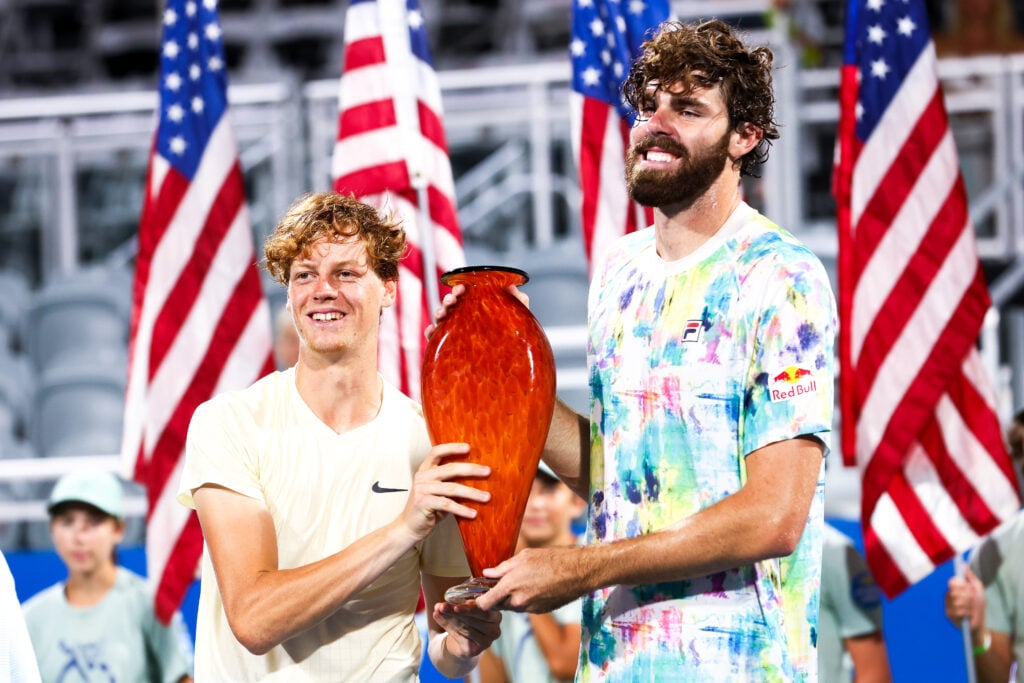 Jannik Sinner of Italy and Reilly Opelka of the United States pose for photos with the winners trophy after the pair won the doubles final match against Steve Johnson of the United States and Jordan Thompson of Australia at the Truist Atlanta Open.