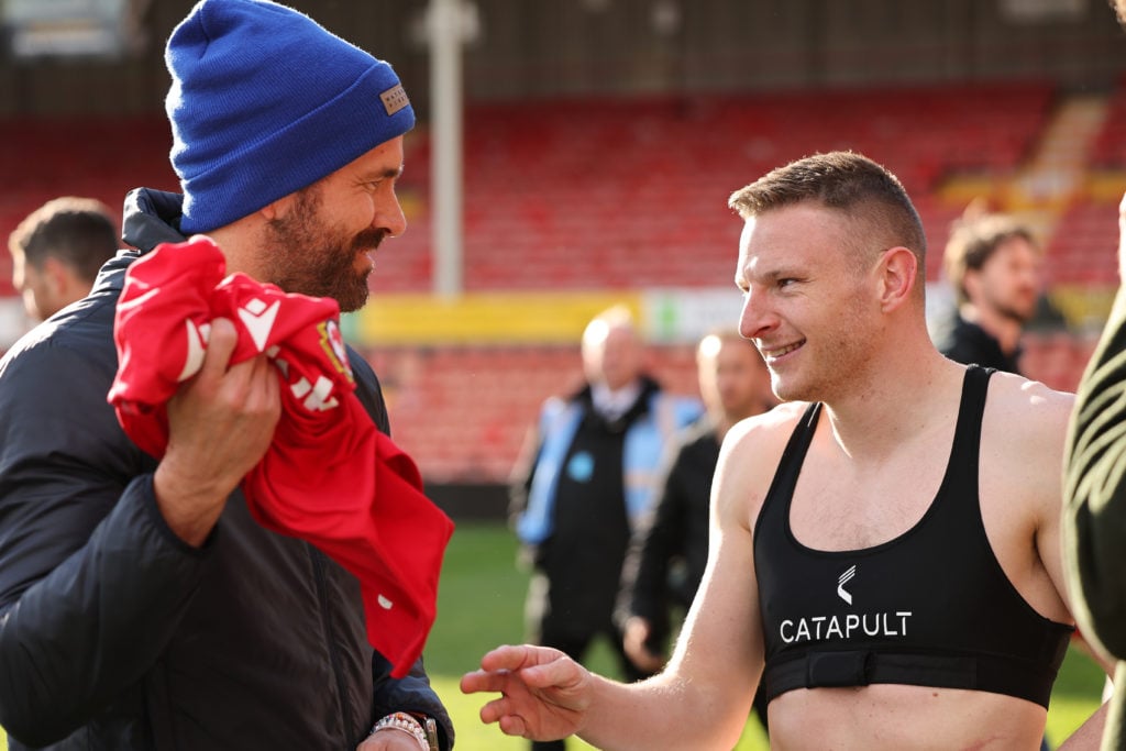 Hollywood actor and co-owner of Wrexham Football Club, Ryan Reynolds takes the shirt of Paul Mullin