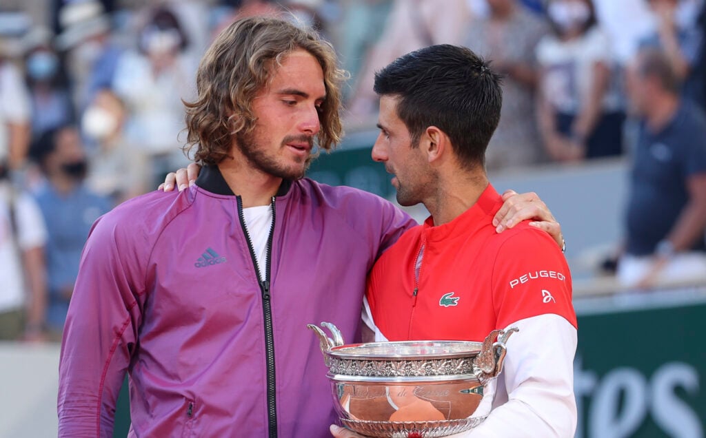 Stefanos Tsitsipas and Novak Djokovic embrace after the 2021 French Open final