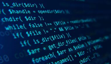 Blue code on a dark background presented at an angle.