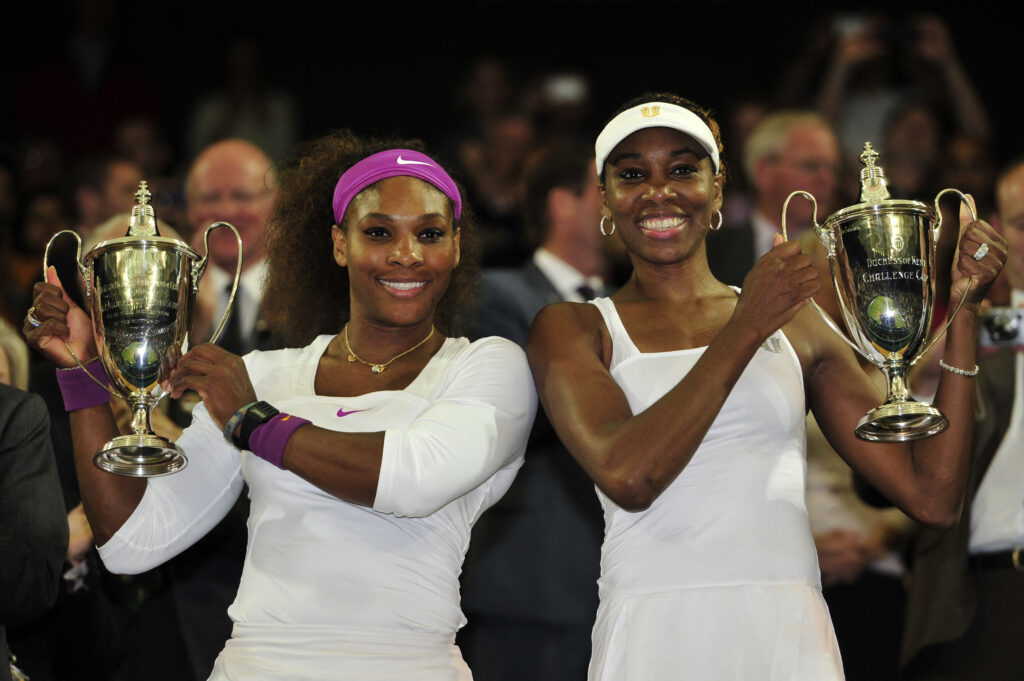 US player Serena Williams (L) and her sister US player Venus WIlliams (R) pose with their trophies after winning their women's doubles final match against Czech Republic's Andrea Hlavackova and Czech Republic's Lucie Hradecka on day 12 of the 2012 Wimbledon Championships tennis tournament at the All England Tennis Club in Wimbledon, southwest London, on July 7, 2012.
