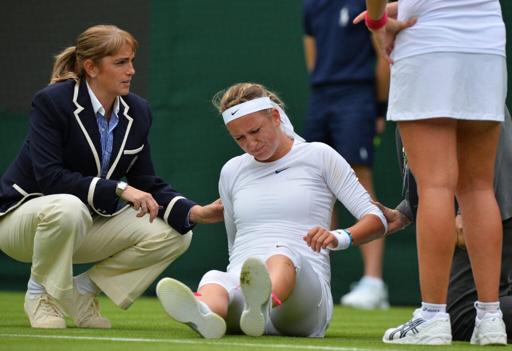 Victoria Azarenka receives attention after falling heavily on court during a point against Portugal's Maria Joao Kohler during their women's first round match on day one of the 2013 Wimbledon Championships tennis tournament at the All England Club in Wimbledon.