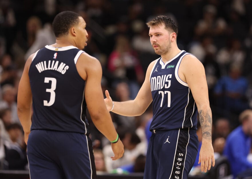 Luka Doncic #77 and Grant Williams #3 of the Dallas Mavericks react during the third quarter against the San Antonio Spurs.