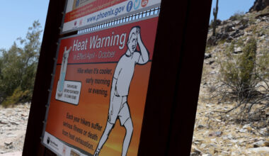 A sign about extreme heat is posted at the Piestewa Peak trailhead on June 5, 2024, in Phoenix, Ari...
