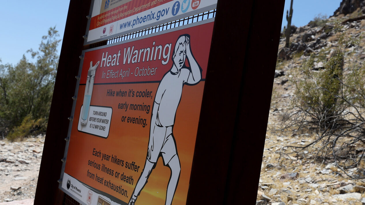 A sign about extreme heat is posted at the Piestewa Peak trailhead on June 5, 2024, in Phoenix, Ari...