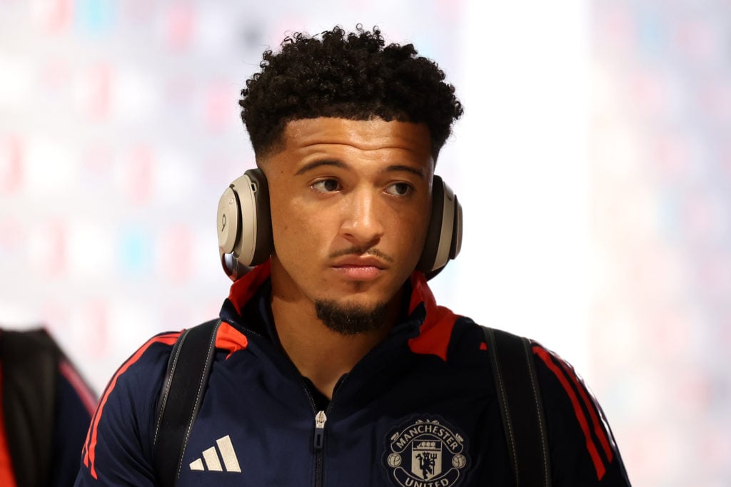 Jadon Sancho before facing Man City in 2024 with headphones on.