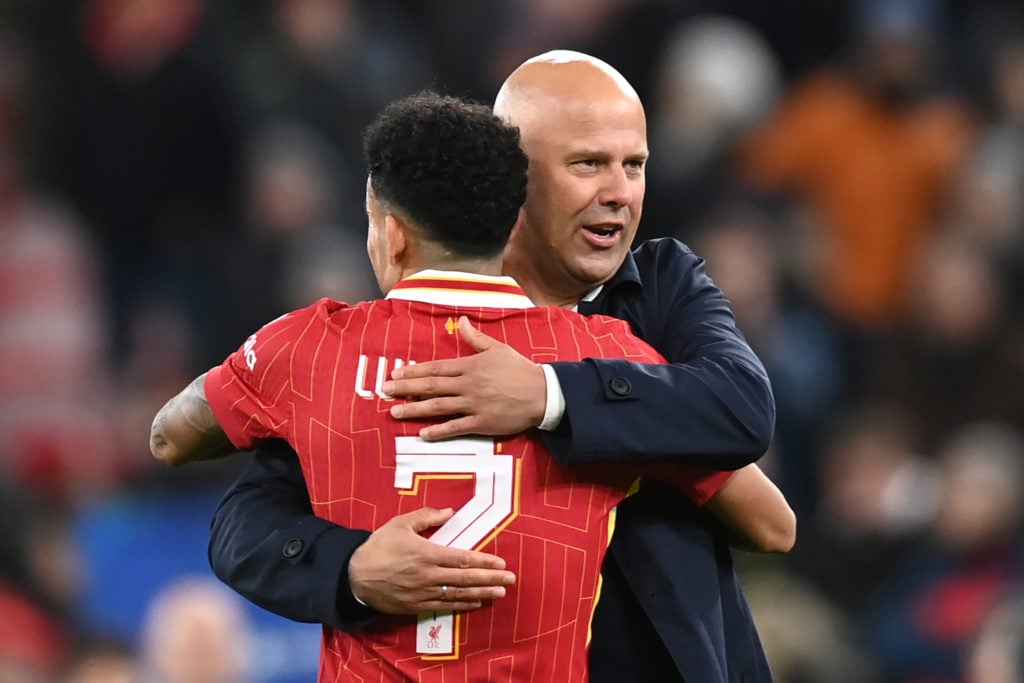 Luis Diaz and Arne Slot share a hug after Liverpool's UEFA Champions League match against Real Madrid at Anfield.